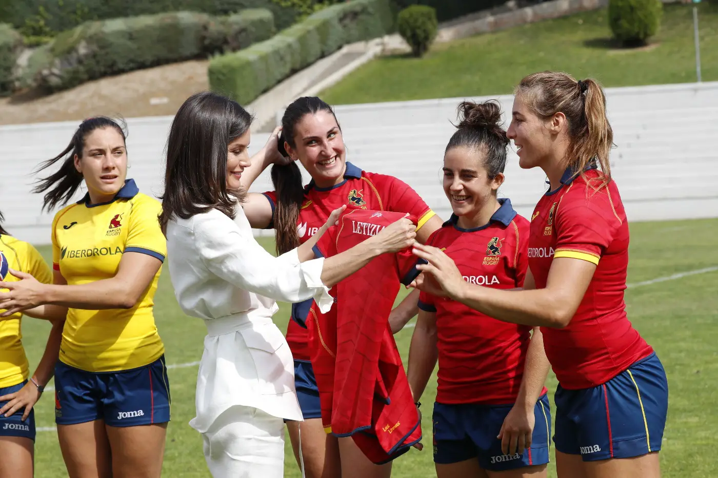 Queen letizia in white carolina herrera belted shirt for women rugby team trainin session