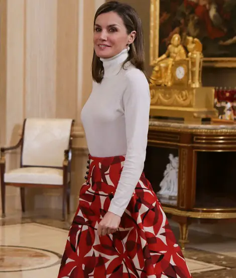 King Felipe and Queen Letizia of Spain today welcomed the Spanish Winter Olympic Team at Royal Palace of Zarzuela in Madrid. Their Majesties congratulated the team for their achievements in the Olympic Games of PyeongChang 2018. Queen Letizia in Favourite Red for Audience with Spanish Winter Olympic Team CasaReal The Team was accompanied by the president of the Spanish Olympic Committee, Alejandro Blanco Bravo. Queen Letizia in Favourite Red for Audience with Spanish Winter Olympic Team CasaReal Felipe and Letizia greeting the team players. Queen Letizia in Favourite Red for Audience with Spanish Winter Olympic Team CasaReal Don Felipe and Doña Letizia observing a shirt signed by the Spanish Olympic Team. Queen Letizia in Favourite Red for Audience with Spanish Winter Olympic Team CasaReal For the audience, Queen chose the colours of Spanish Olympic team white and red. Queen Letizia Hugo Boss Iddyana Knitted Jumper Hugo Boss Iddyana Knitted Jumper Today Letizia wore a new winter white turtleneck top from Hugo Boss.'Iddyana' knit jumper from the BOSS Orange line features a polo neck and long sleeves with sheer pattern. The top is available at Zalando for £71.24. Queen Letizia Carolina Herrera Red Printed Skirt Carolina Herrera Red Printed Skirt Letizia paired the top with Carolina Herrera red printed skirt. She wore the skirt for meeting with the Spanish Association against Cancer (AECC) last December. Queen Letizia Magrit Red Suede Boots Magrit Red Suede Boots Once again Queen brought her red suede boots by Magrit that we have seen many times during this winter. Queen Letizia TOUS cultured freshwater pearl drop earrings TOUS cultured freshwater pearl drop earrings Letizia complimented the look with TOUS cultured freshwater pearl drop earrings. Queen Letizia in Favourite Red for Audience with Spanish Winter Olympic Team CasaReal