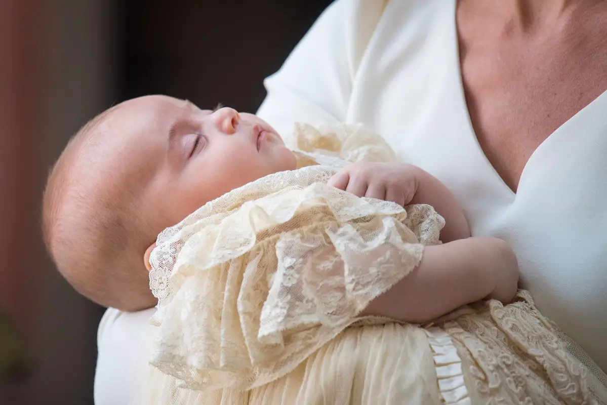 Prince Louis in his mother arms at his christening