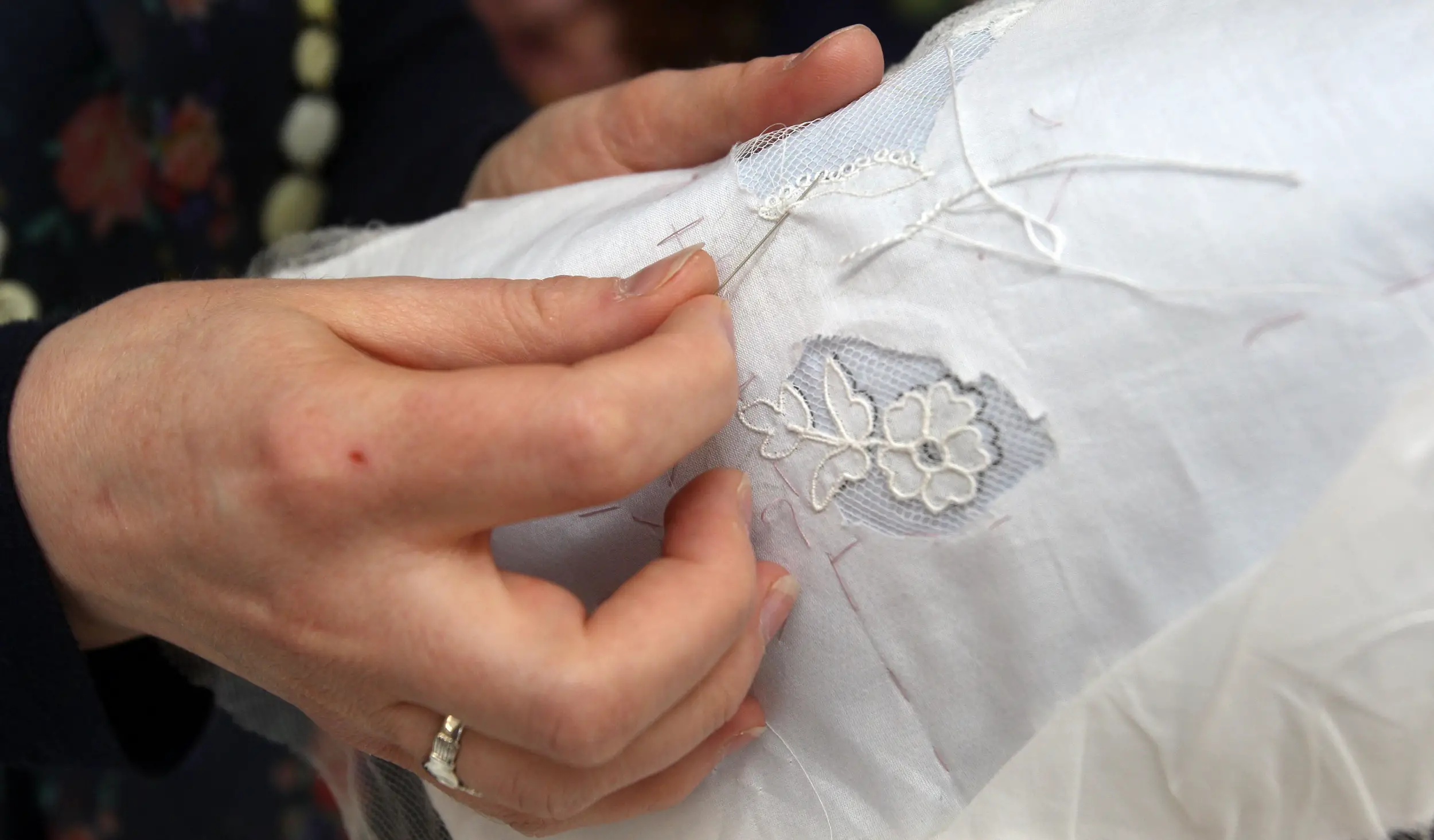 Jenny Adin-Christie, 33, an embroiderer from Chessington, who worked on the Duchess of Cambridge's Wedding Dress, demonstrates the applique embroidery technique similar, but not the same as that used on the Wedding Dress, at the Royal School of Needlework in Hampton Court Palace, South West London.