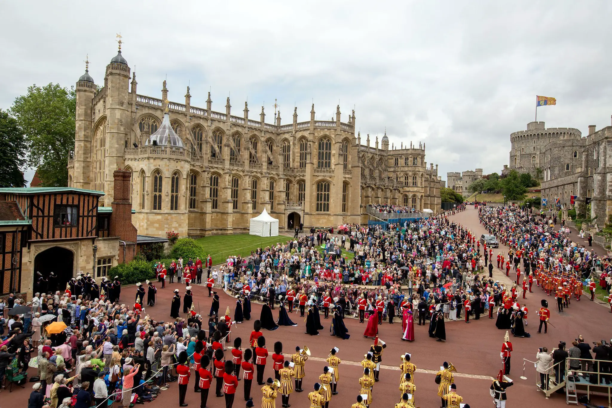 Members of Britain's Royal family and dignitaries take part in the the annual procession for members of the Order of the Garter ahead of the service at St George's Chapel, Windsor Castle England Monday June 16, 2014. At left is St Georges Chapel and at right Windsor Castle. (AP Photo/Steve Parsons/Pool)