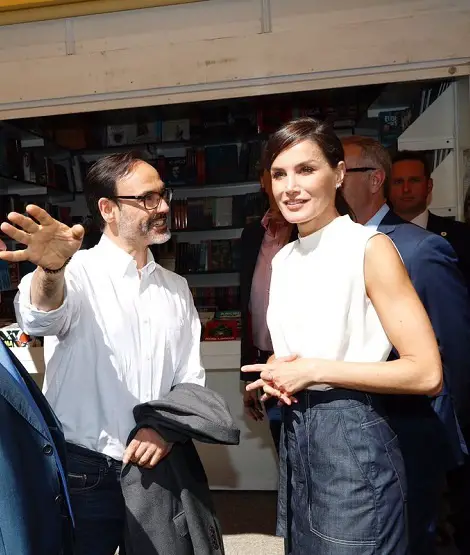 Queen Letizia wore a summer white top and blue denim skirt for madrid book fair 1