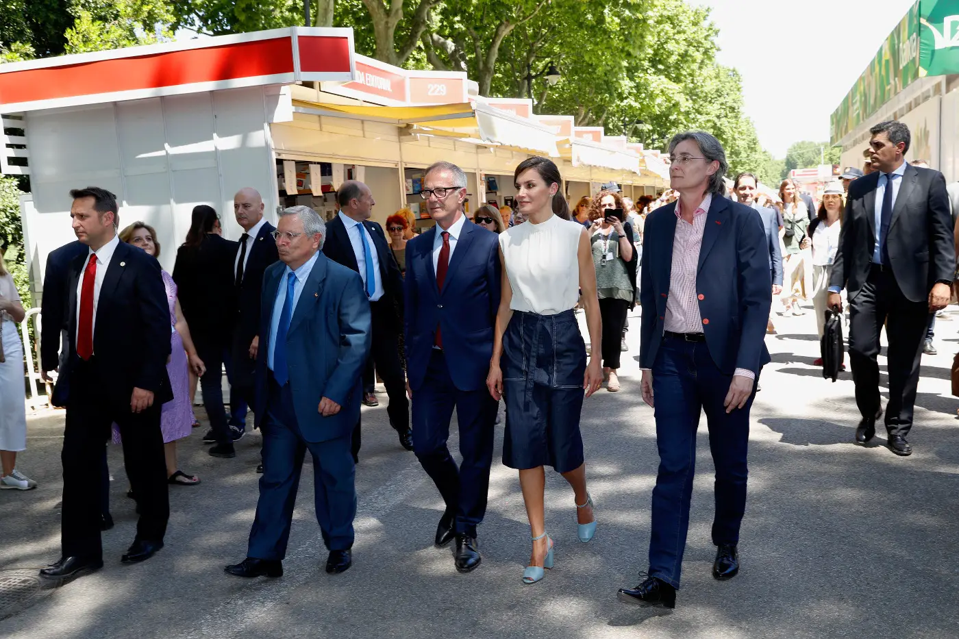 Queen Letizia wore a summer white top and blue denim skirt for madrid book fair