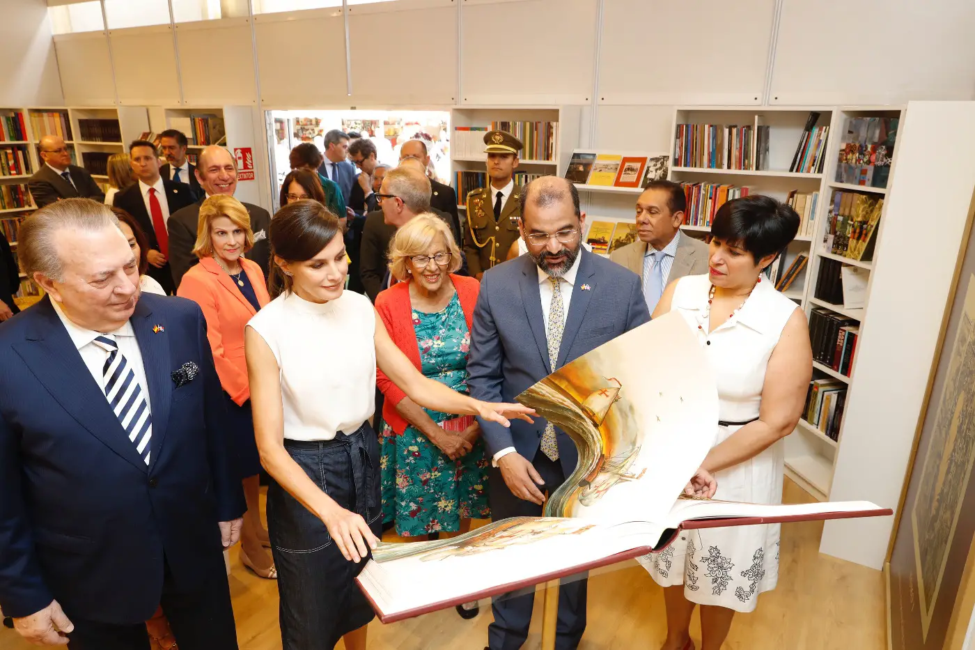 Queen Letizia wore a summer white top and blue denim skirt for madrid book fair