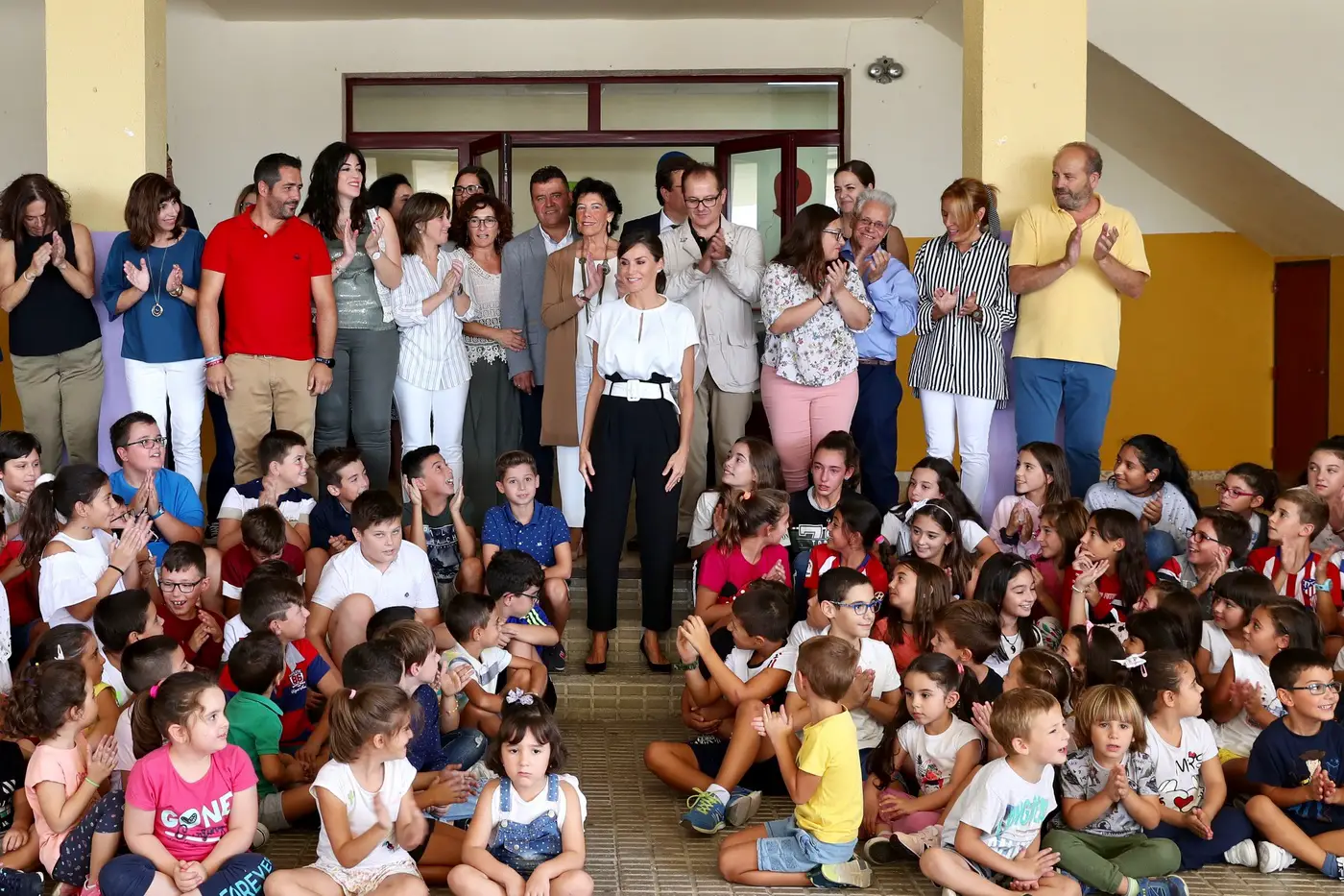 Queen Letizia wore white satin blouse with Uterque white belted trouser for school session opening