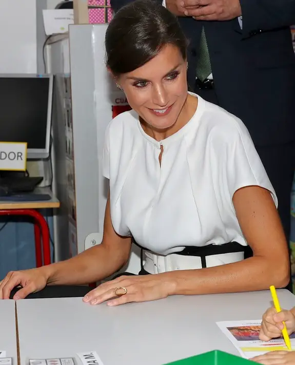 Queen Letizia wore white satin blouse with Uterque white belted trouser