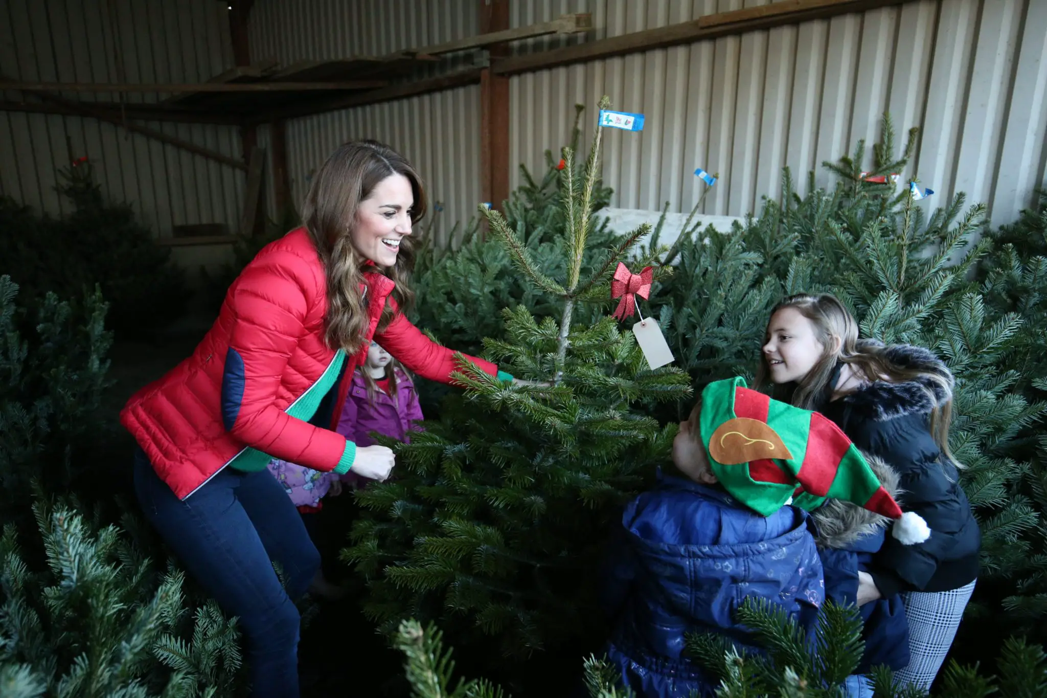 The Duchess of Cambridge helped children pick up Christmas tree during Family Action visit