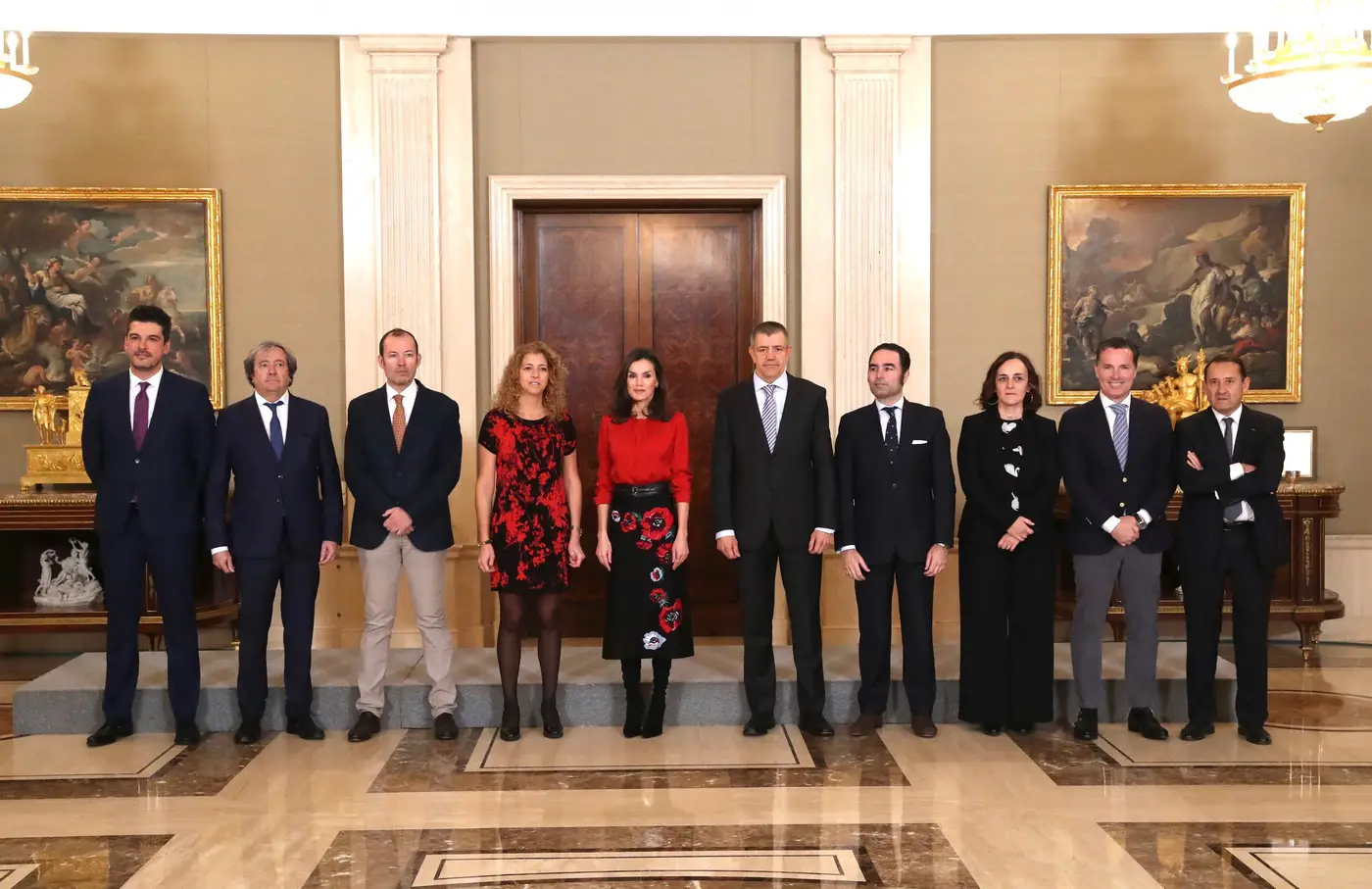 Queen Letizia received audience at palace wearing red hugo boss blouse and black and red carolina Herrera skirt