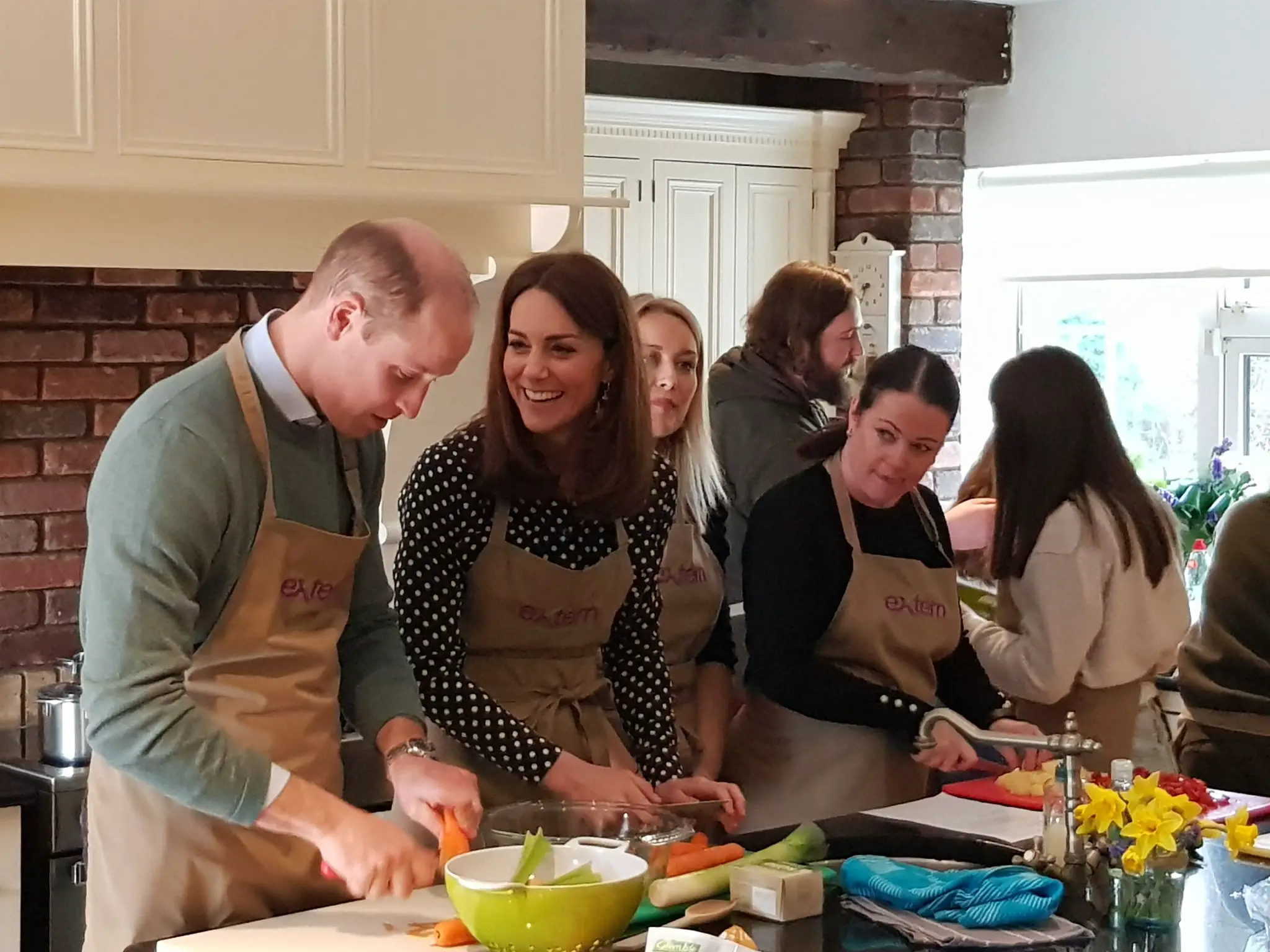 The Duchess of Cambridge helped in chopping carrots to make soup while Prince William tried his hand at mixing cookie dough for making cookies.