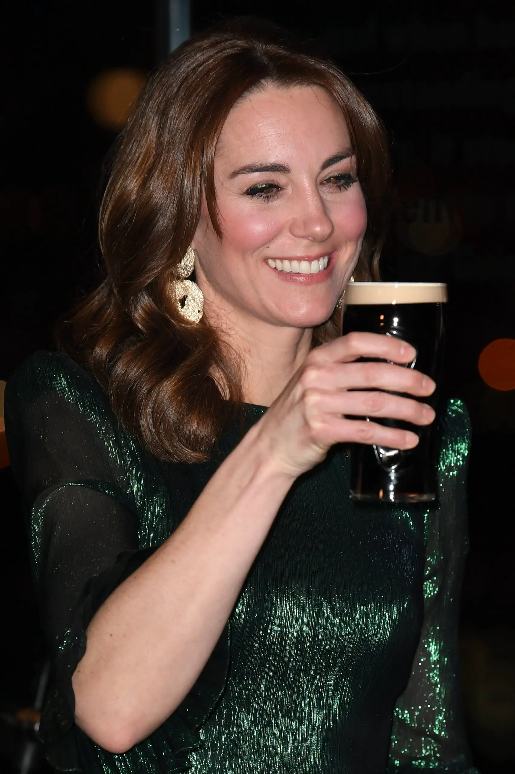 The Duchess of Cambridge holds a pint of Guinness during a reception hosted by the British Ambassador to Ireland at the Gravity Bar, Guinness Storehouse, Dublin, during a three day visit to the Republic of Ireland with her husband the Duke of Cambridge.