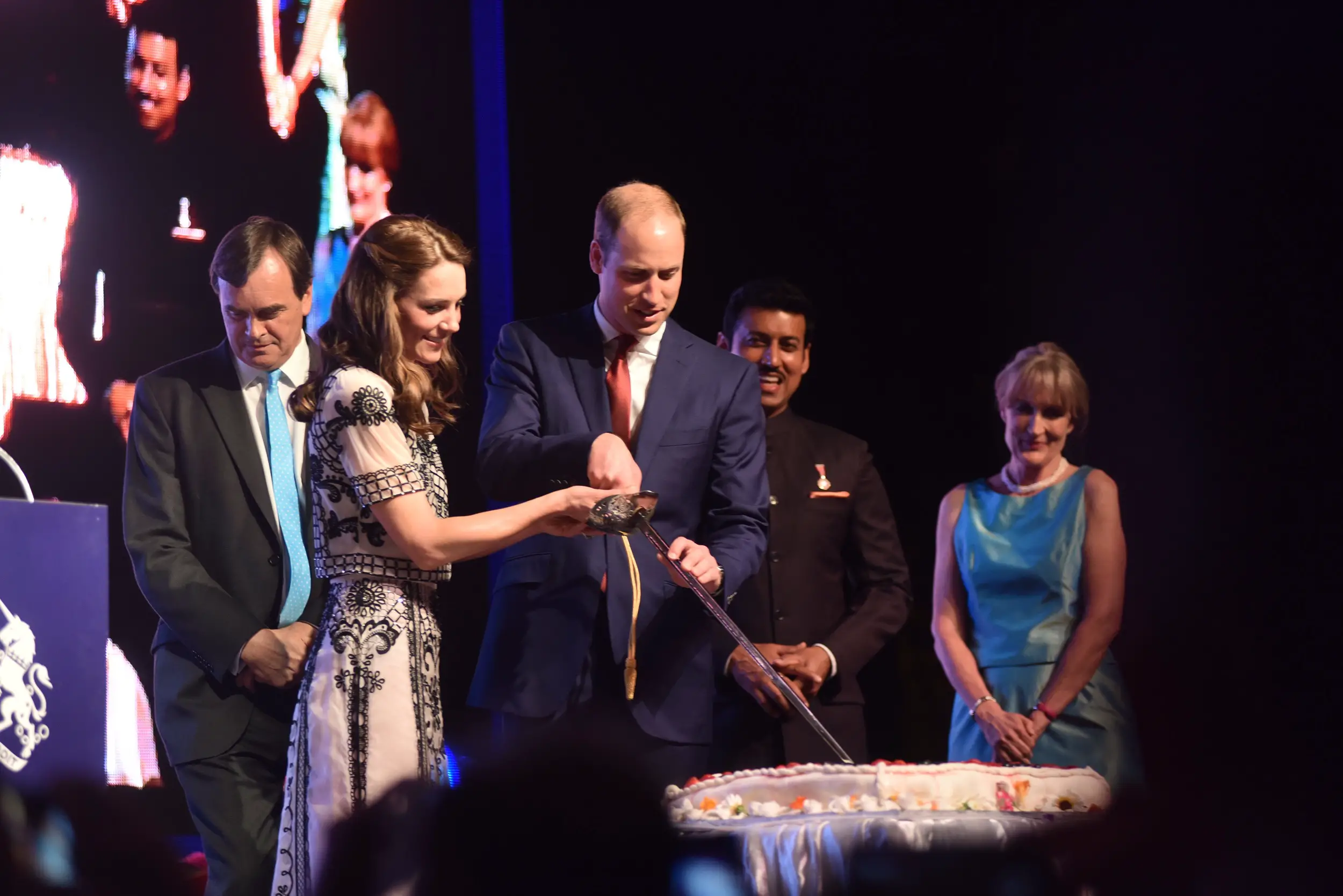 William and Catherine cut the cake using a decorated sword