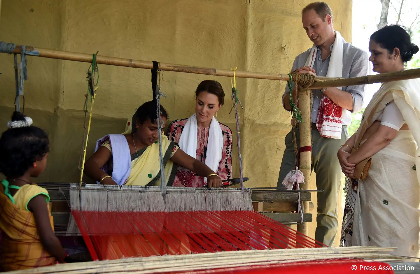 The Duke and Duchess sat on a mat covered floor with people and heard about their lifestyle