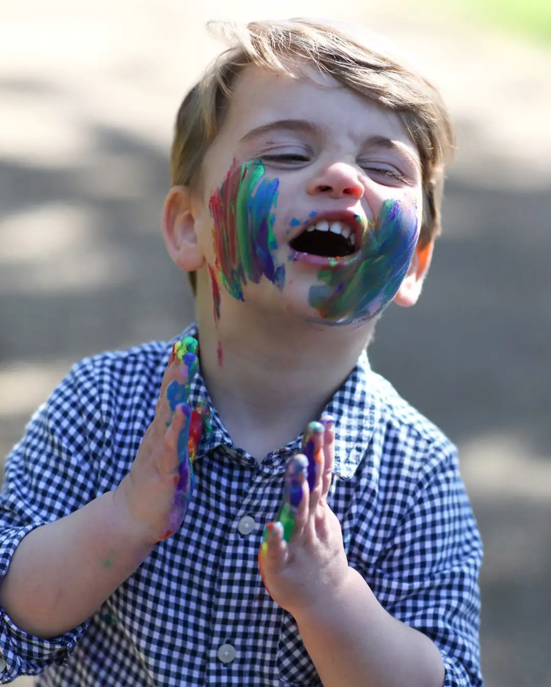 Prince Louis of Cambridge with rainbow paint on his face in his birthday pictures