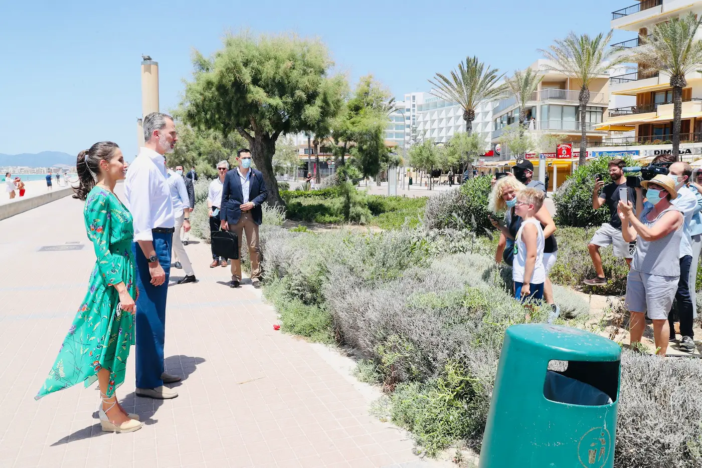 King Felipe and Queen Letizia of Spain talk with some tourists during their walk along the promenade in Palma