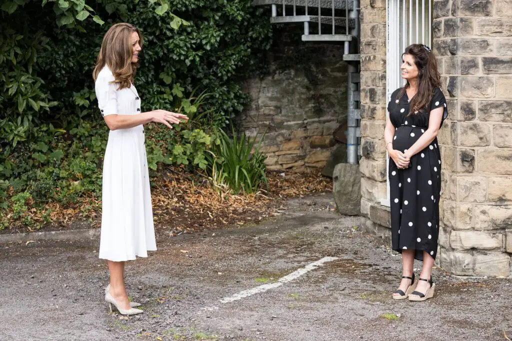 The Duchess of Cambridge wore Suzannah London Flippy Wiggle Tea Dress to visit Baby Basics
