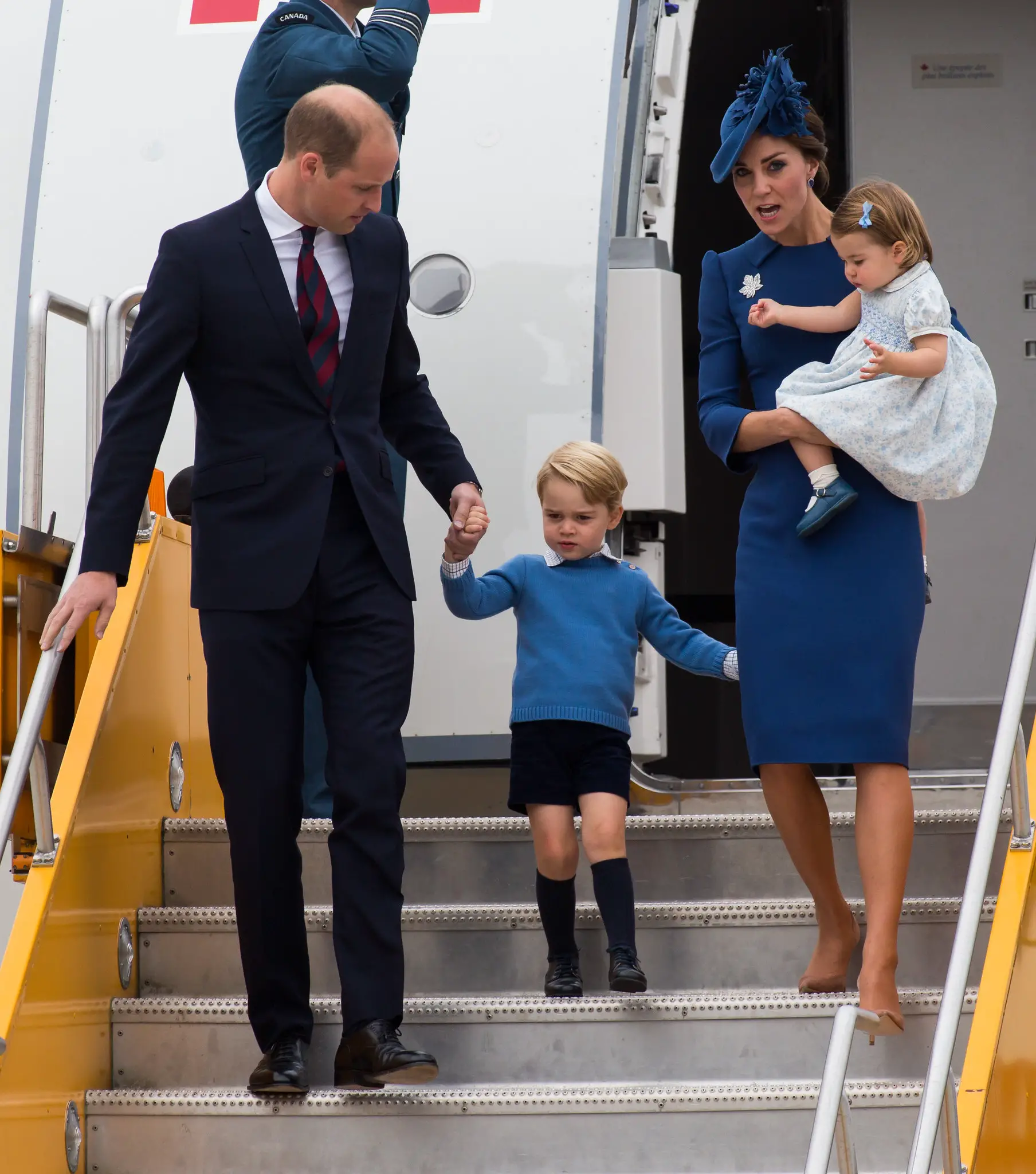 The Duchess of cambridge holding Princess Charlotte during Canada arrival in 2016