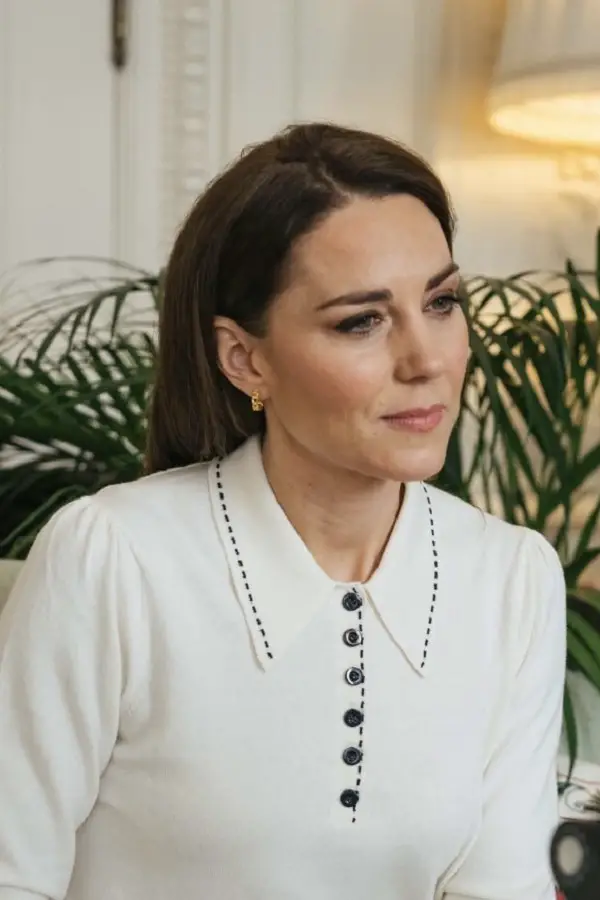 The Duchess of Cambridge wears LK Bennett Liv Cream Cotton-Merino Wool Collared Jumper in February 2020 during a video call to Baby Bank Charity